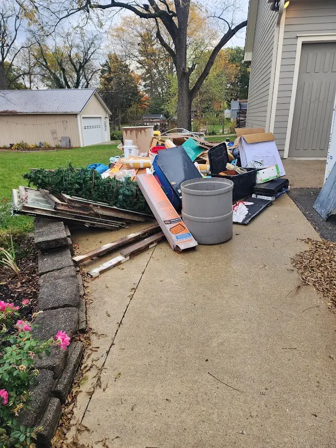Dumpster being loaded with debris for 12 Yard Dumpster Rental in Snoqualmie